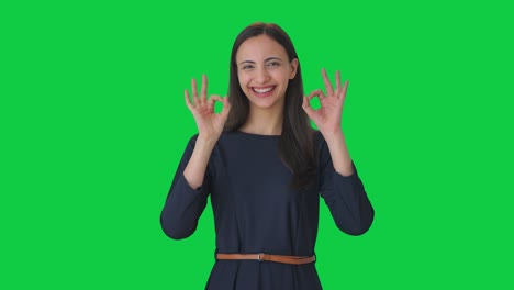 Happy-Indian-girl-showing-Okay-sign-Green-screen