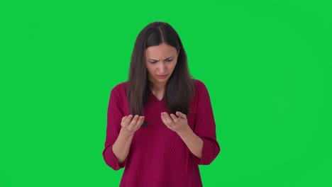 Stressed-Indian-woman-worried-about-hair-fall-Green-screen