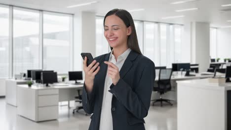 Happy-Indian-business-woman-using-phone
