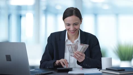 Happy-Indian-business-woman-counting-money