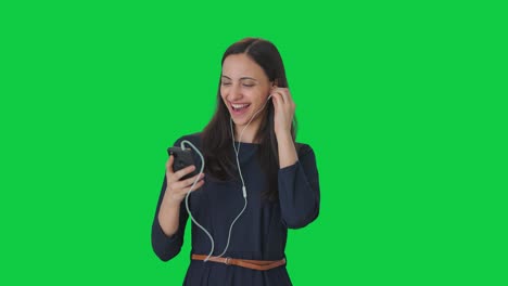 Happy-Indian-girl-listening-songs-and-enjoying-Green-screen