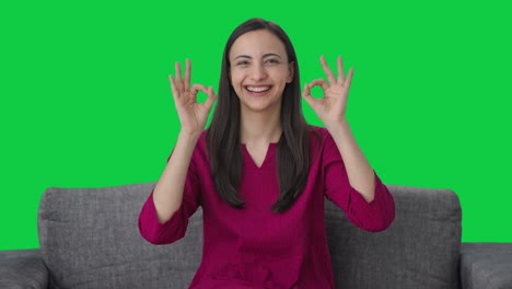 Happy-Indian-woman-showing-okay-sign-Green-screen