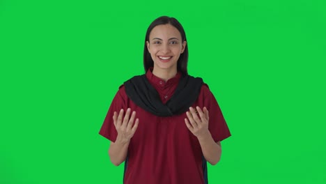 Happy-Indian-female-hotel-staff-talking-to-guests-Green-screen