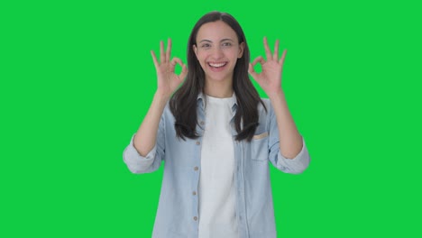 Happy-Indian-girl-showing-okay-sign-Green-screen