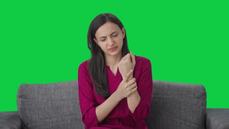 Sick-Indian-woman-suffering-from-hand-pain-Green-screen