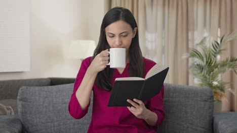 Indian-woman-reading-a-book-and-drinking-coffee