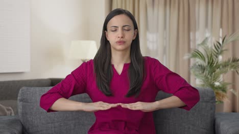 Indian-woman-doing-breathe-in-breathe-out-exercise