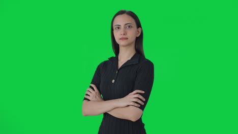 Portrait-of-Indian-female-news-journalist-standing-crossed-hands-Green-screen