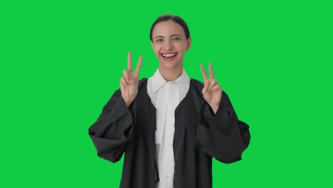 Happy-Indian-female-lawyer-showing-victory-sign-Green-screen