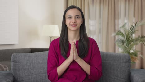 Happy-Indian-woman-waving-doing-Namaste
