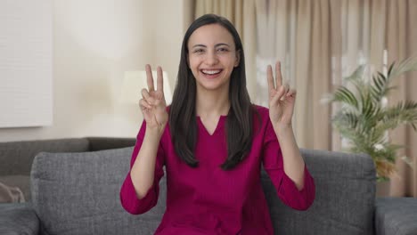 Happy-Indian-woman-showing-victory-sign