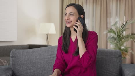 Happy-Indian-woman-talking-with-someone-on-call