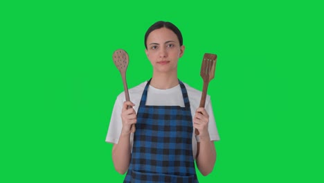 Indian-housewife-posing-with-spoon-and-spatula-Green-screen