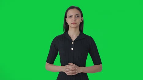 Happy-Indian-female-news-anchor-looking-at-the-camera-Green-screen