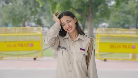 Stressed-Indian-female-police-officer-removing-hat