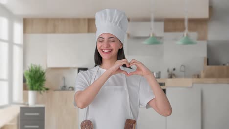 Happy-Indian-female-professional-chef-making-heart-sign