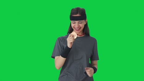Happy-Indian-girl-celebrating-with-medal-Green-screen