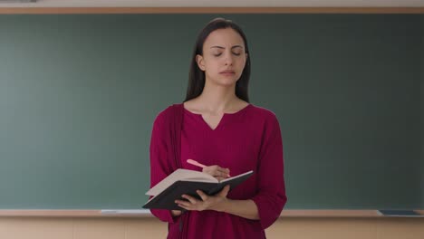 Indian-female-teacher-taking-attendance