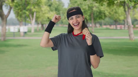 Happy-Indian-girl-posing-with-medal