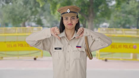 Upset-Indian-female-police-officer-showing-thumbs-down