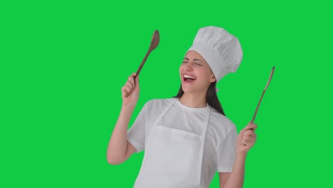 Excited-Indian-female-professional-chef-dancing-and-enjoying-Green-screen