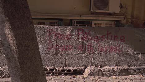 Political-inscription-on-old-stone-wall-in-residential-district