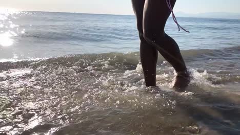 Anonymous-black-woman-walking-on-beach