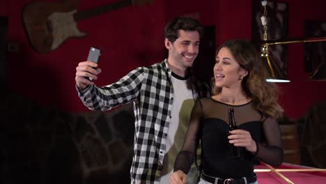 Delighted-couple-taking-selfie-in-bar