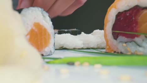 Crop-chef-making-sushi-in-restaurant