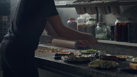 Preparing-vegetarian-pizza-in-restaurant-kitchen