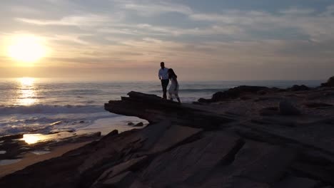 Loving-bride-and-groom-on-seashore-at-sunset
