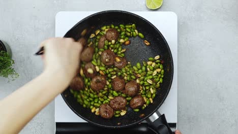Woman-cooking-green-beans-and-meatballs