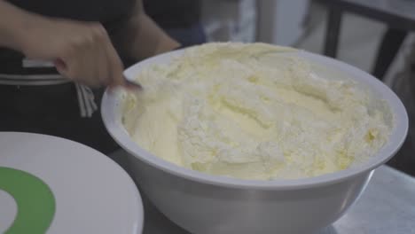 Anonymous-confectioner-mixing-sweet-cream-for-cake