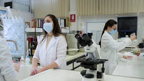 Scientist-washing-hands-in-laboratory
