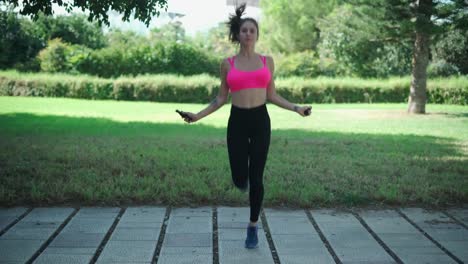 Woman-doing-exercise-with-jumping-rope-in-park