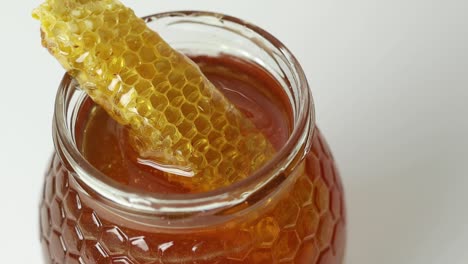 Honey-with-honeycomb-in-glass-jar