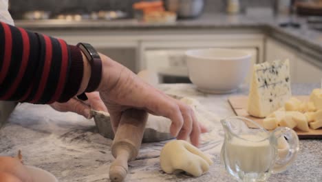 Crop-cook-preparing-crust-for-quiche-in-kitchen-at-home