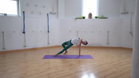 Flexible-woman-performing-Three-Legged-Downward-Facing-Dog-pose-indoors