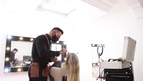 Male-makeup-artist-working-with-female-model