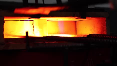 Metal-detail-burning-in-furnace-in-workshop