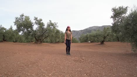 Asian-woman-jumping-near-olive-trees