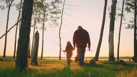 hiking-and-fishing-in-nature-in-summer-weekend-old-fisherman-and-his-grandson-are-walking-to-river