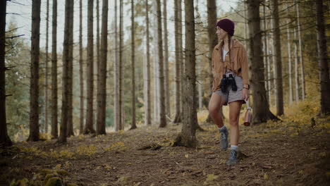 Female-tourist-walking-in-forest-during-vacation