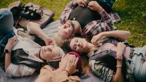 Friends-Laughing-While-Lying-Down-On-Grass