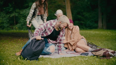 Happy-Male-And-Female-Friends-During-Picnic-At-Park