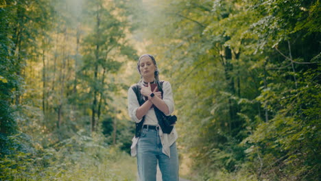 Worried-Female-Hiker-With-Book-In-Forest