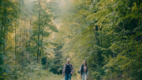 Happy-Friends-Strolling-Amidst-Trees-In-Forest