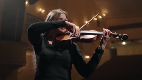 young-woman-musician-is-playing-violin-in-music-hall-portrait-of-woman-with-fiddle