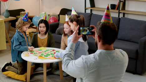 Children-with-party-hats-playing-board-game