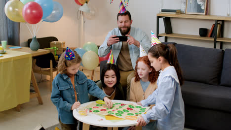 Children-with-party-hats-playing-board-game